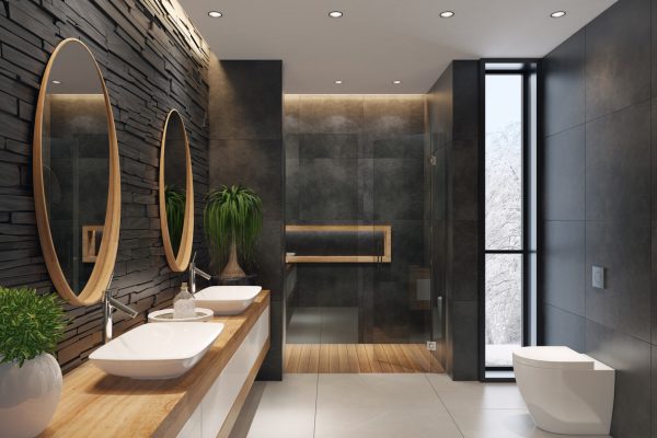contemporary minimalist bathroom with two round mirrors and wooden frame.
natural stacked black matte stone wall with large black matte tiles.
two rectangular white wash basins are on top of the long wooden cabinet with
white doors. large white matte floor tiles. wooden floor tiles in walk-in shower.
ceiling strip cove lighting with embedded spotlights.